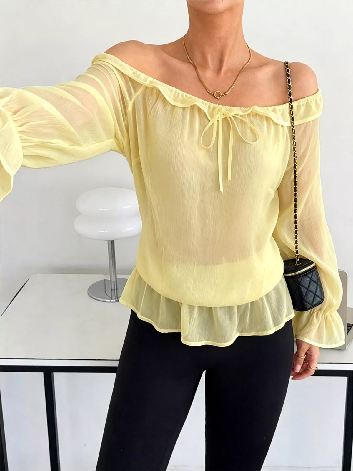 Light yellow off-shoulder chiffon peplum blouse with ruffle trim and tie neckline