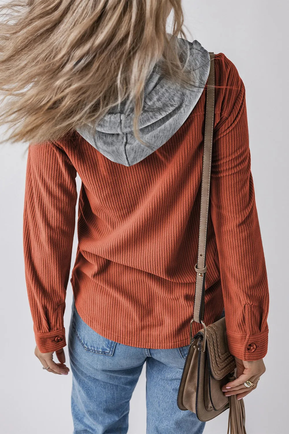 Orange-red ribbed hooded button-up jacket with long sleeves and gray drawstring hood.