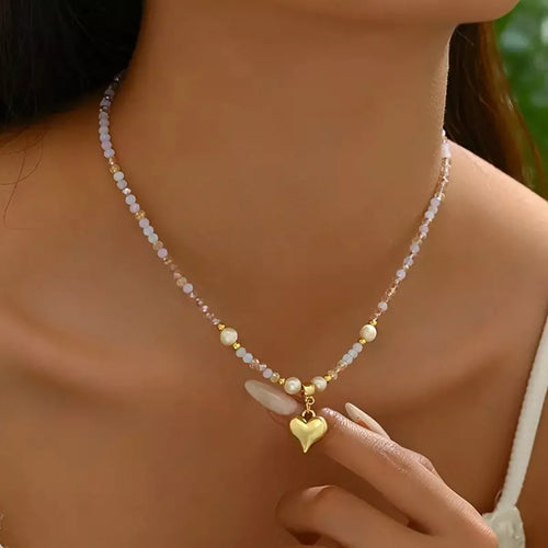 Gold bead heart pendant necklace with small heart charm and white pearl accents