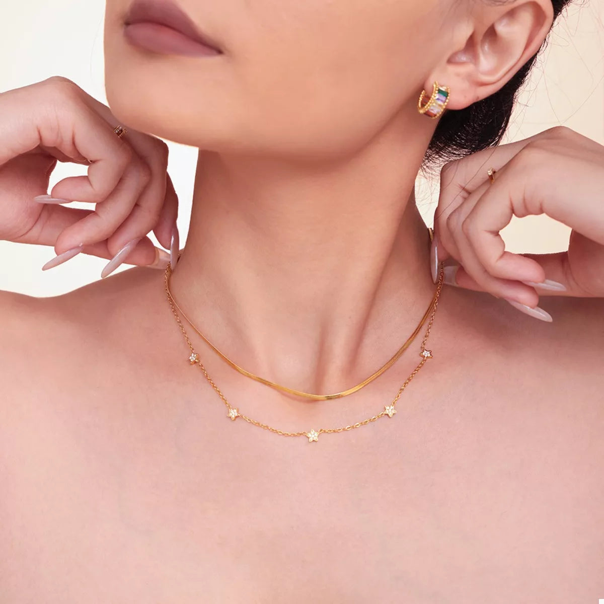 Gold-plated necklace set showing two chains with star-shaped zircon pendant accents