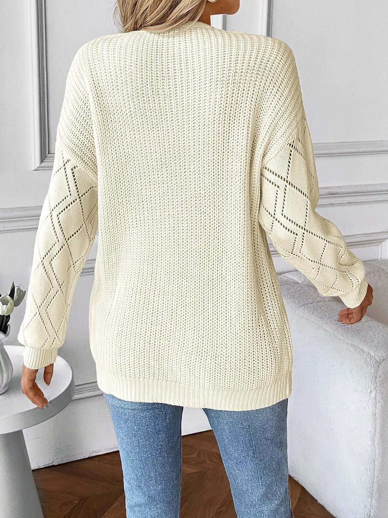 Ivory long sleeve knit sweater back with ribbed hem and subtle openwork pattern