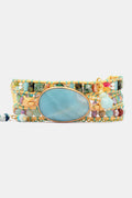 Triple-layer beaded bracelet laid flat, aqua oval center in gold-tone frame with bead bands