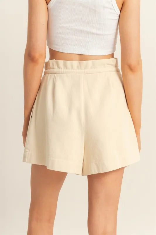 High-waisted oatmeal paperbag shorts with drawstring tie and A-line pleated legs