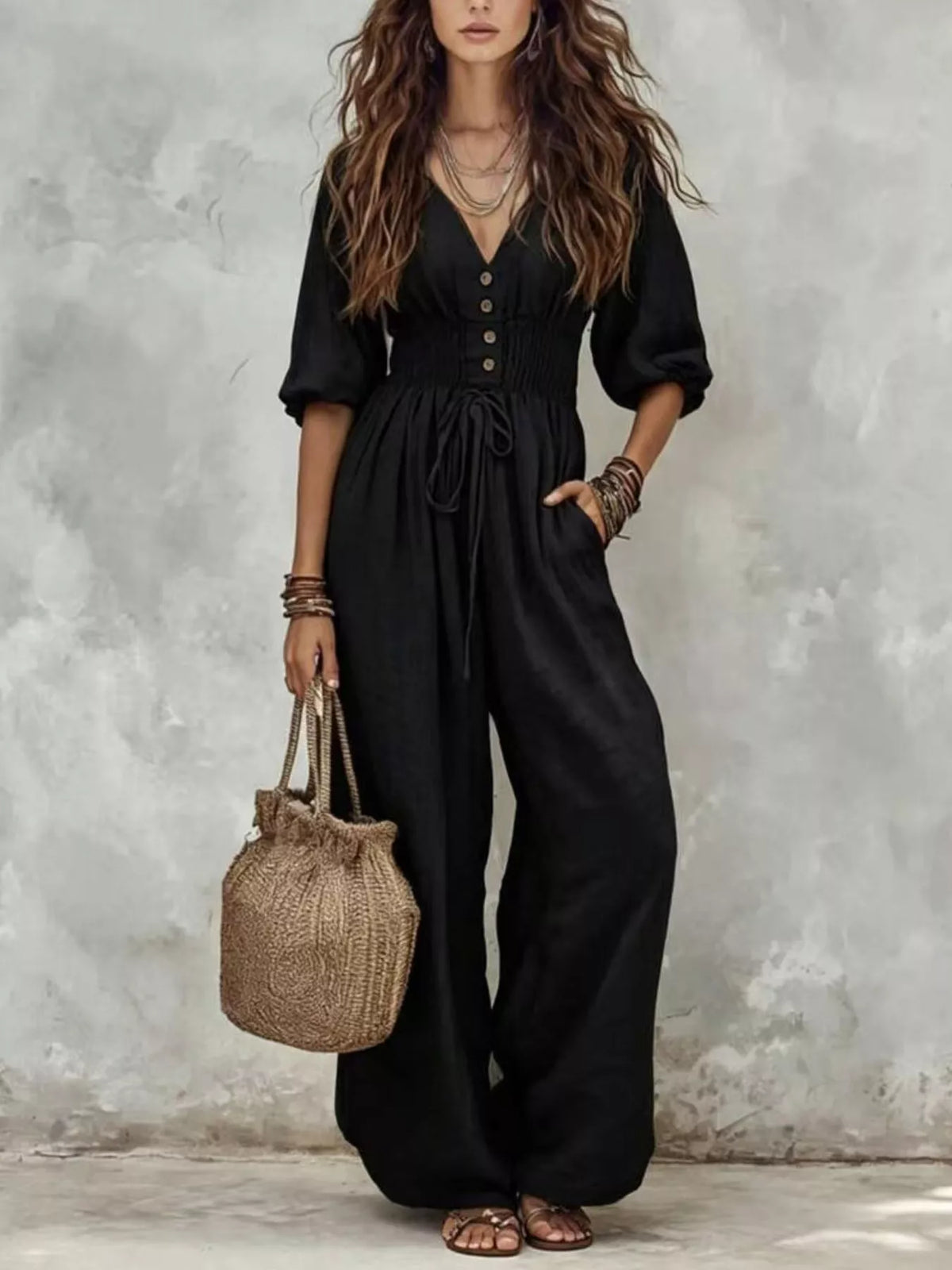 Black v-neck smocked-waist wide-leg jumpsuit with button front and side pockets