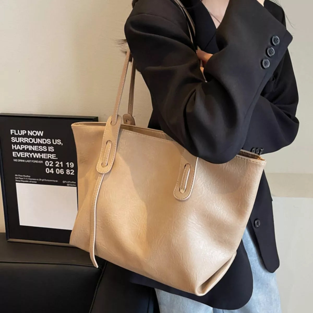 Khaki vegan leather tote bag with adjustable shoulder straps and reinforced handle loops
