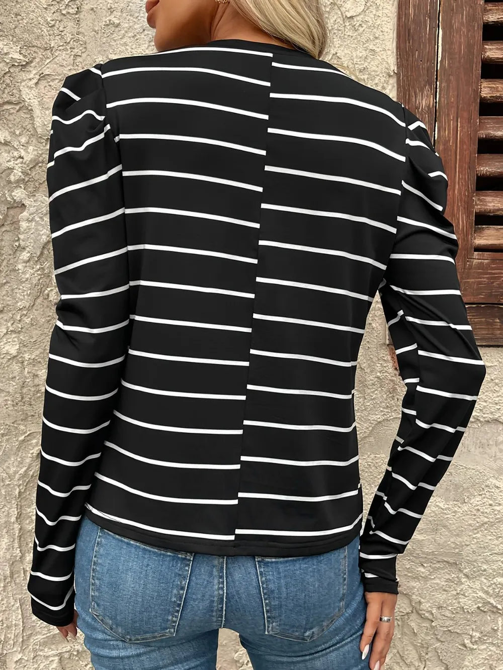 Back view: black-and-white striped round-neck long-sleeve puff t-shirt with ribbed cuffs
