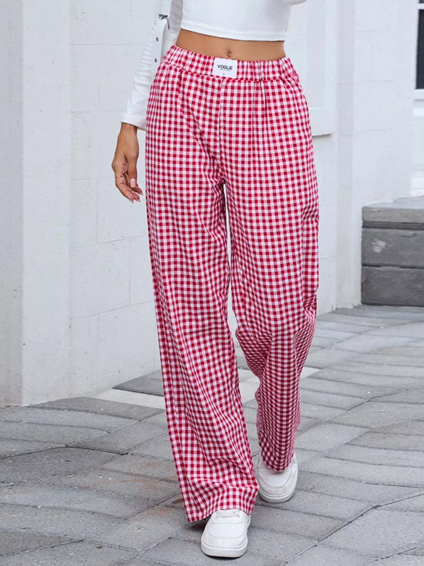 Plaid wide-leg casual pants in red and white, close side view with tapered waistband.