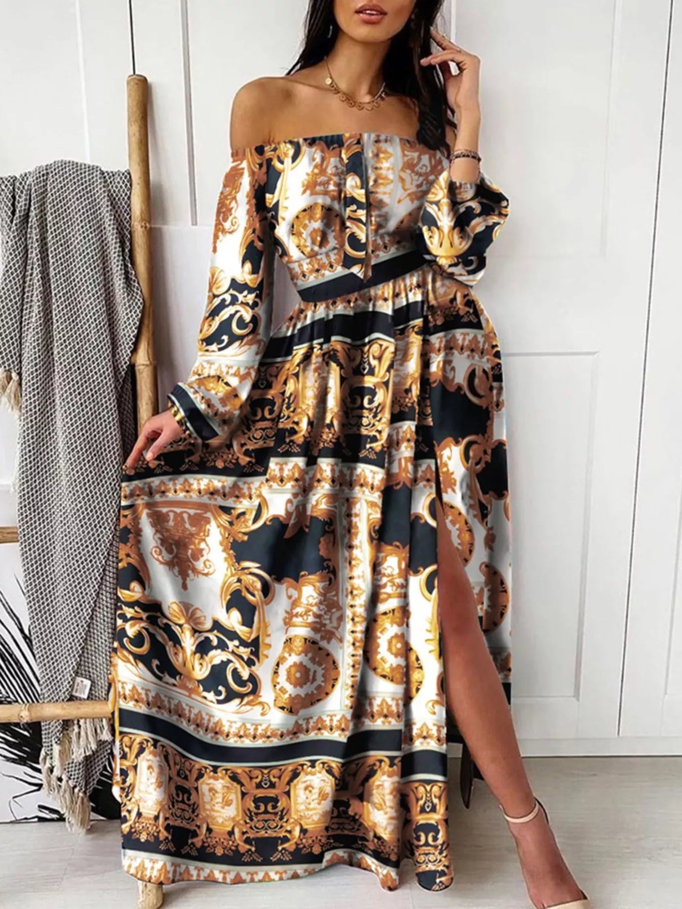 Black and gold ornate printed off-shoulder maxi dress with long sleeves and side slit