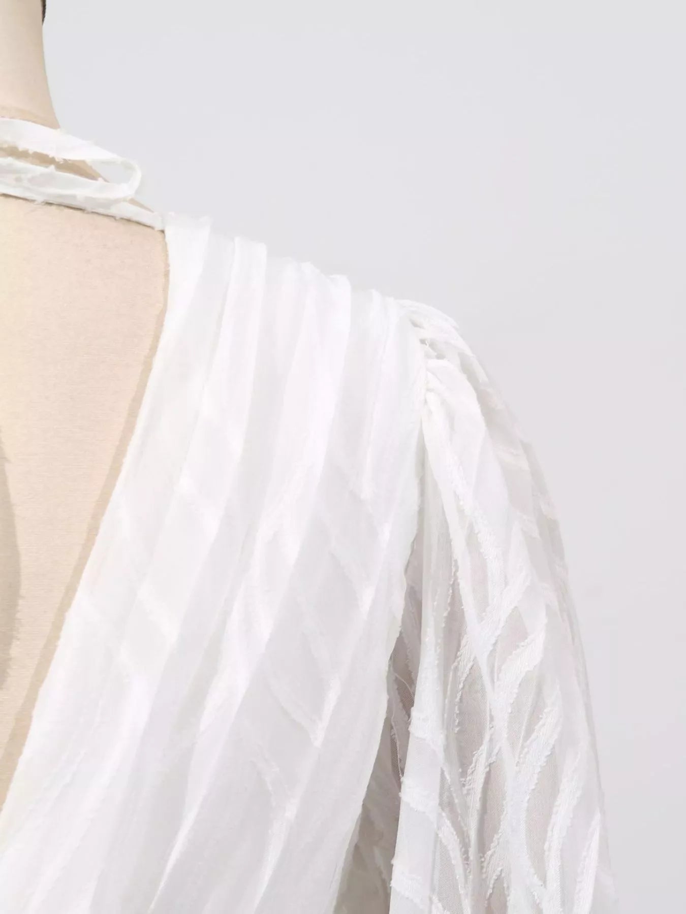 Cedar & Moore V-Neck Long Sleeve Maxi Dress by Trendsi, white textured fabric with tie-neck detail