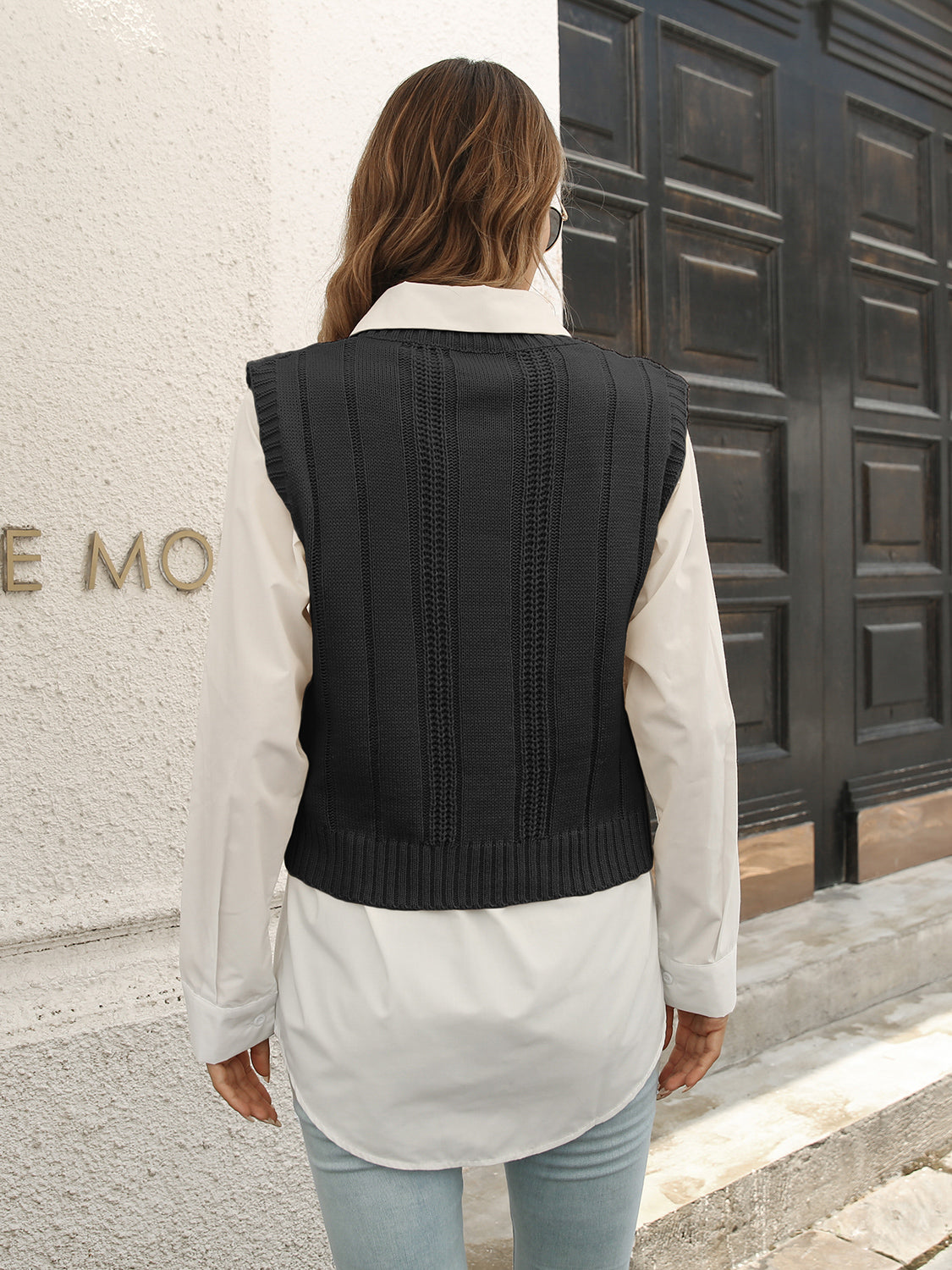 Black V-neck textured knit sweater vest back view with vertical panel
