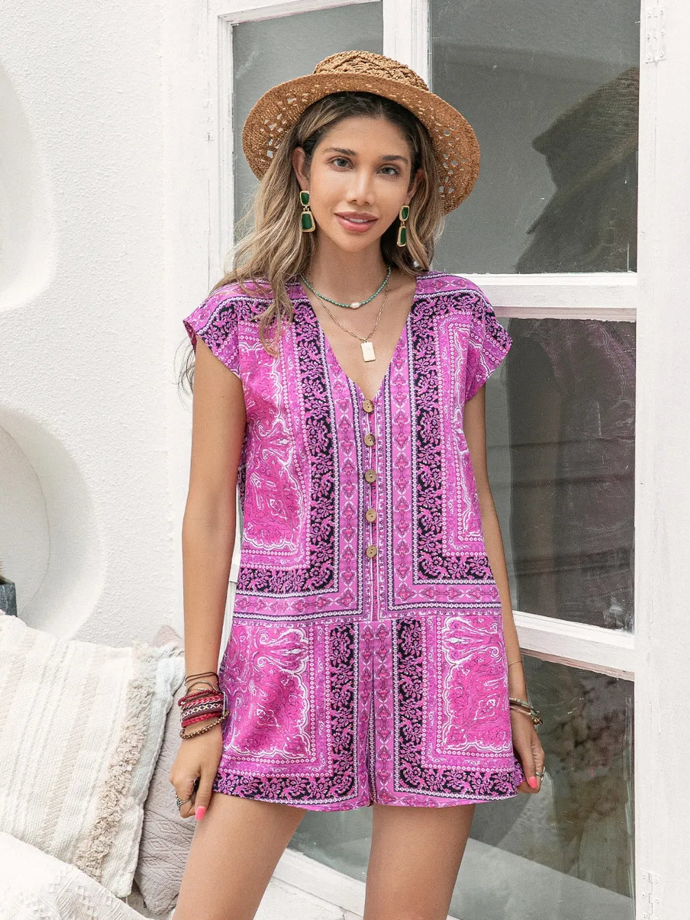 Pink printed v-neck cap sleeve romper with patchwork-style border panels