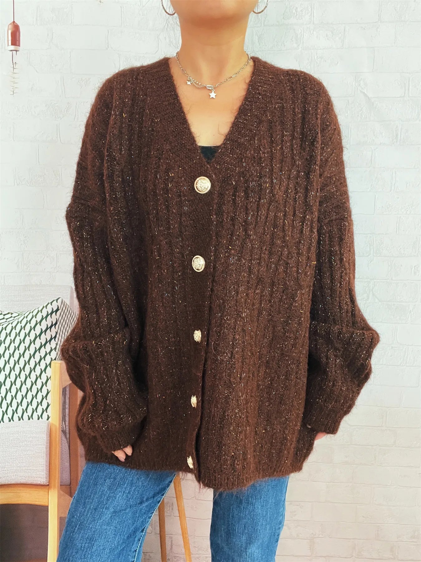 Brown cable-knit cardigan with V-neck and long sleeves, front button placket visible
