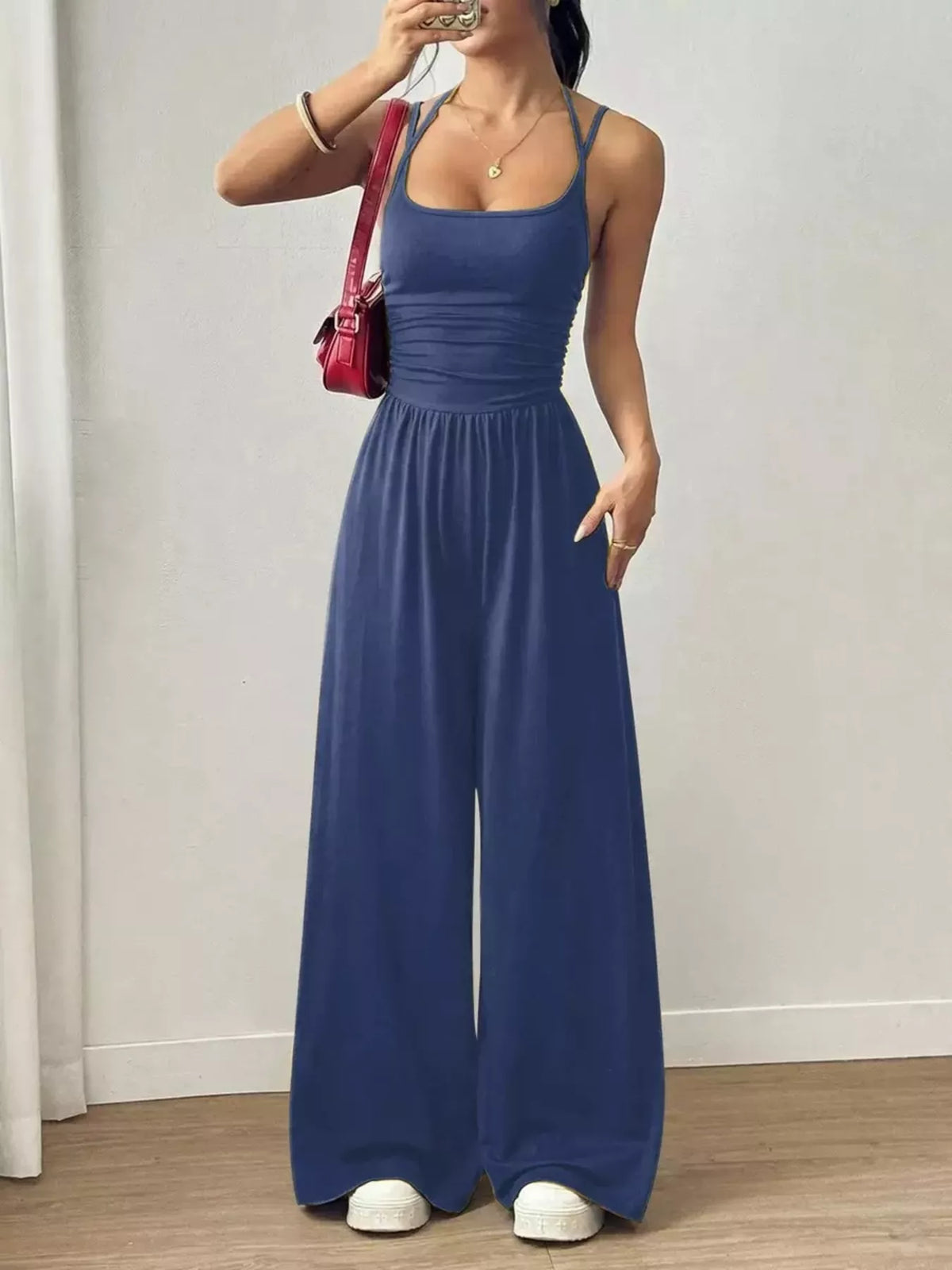 Royal blue spaghetti strap wide-leg jumpsuit with smocked waist and relaxed wide-leg fit