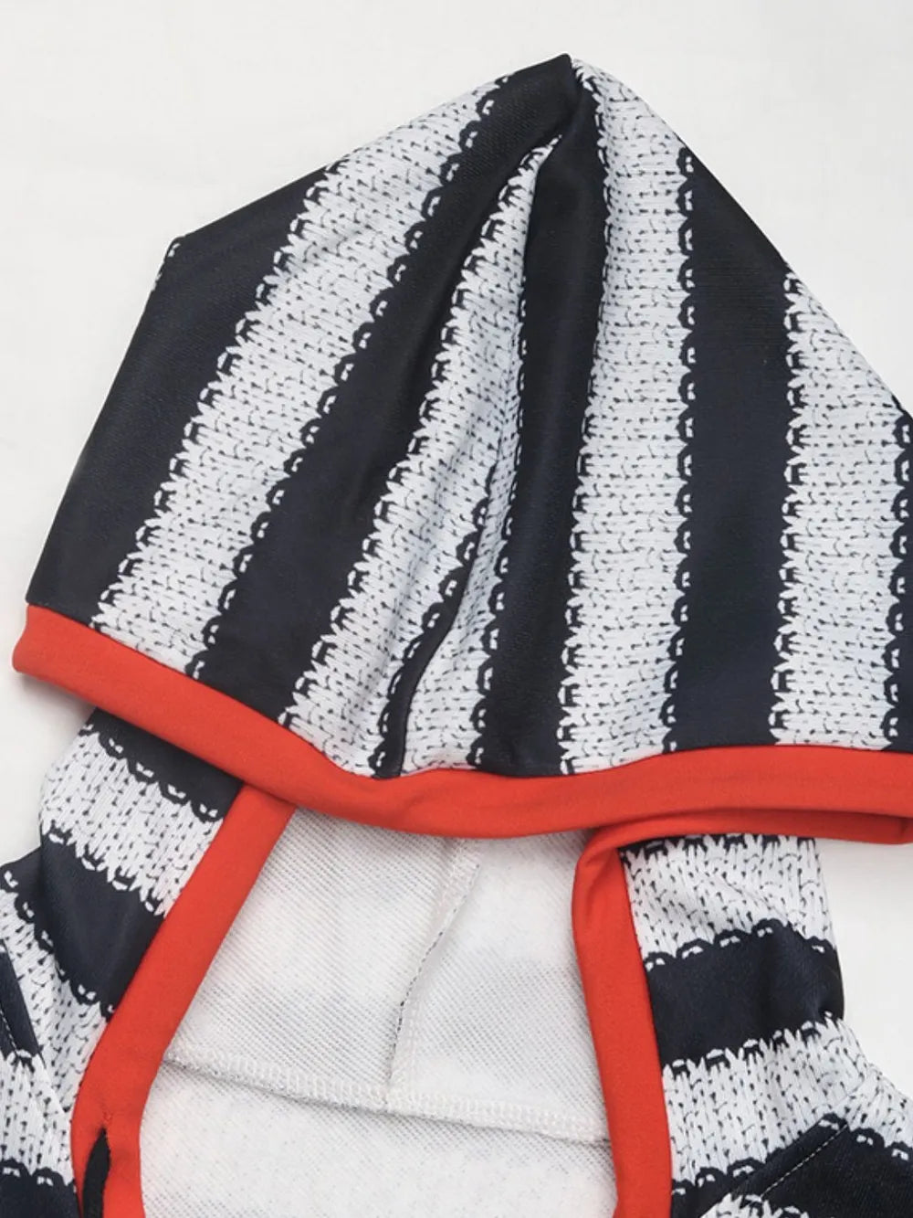 Striped long sleeve hoodie fabric with red trim, black and white alternating bands