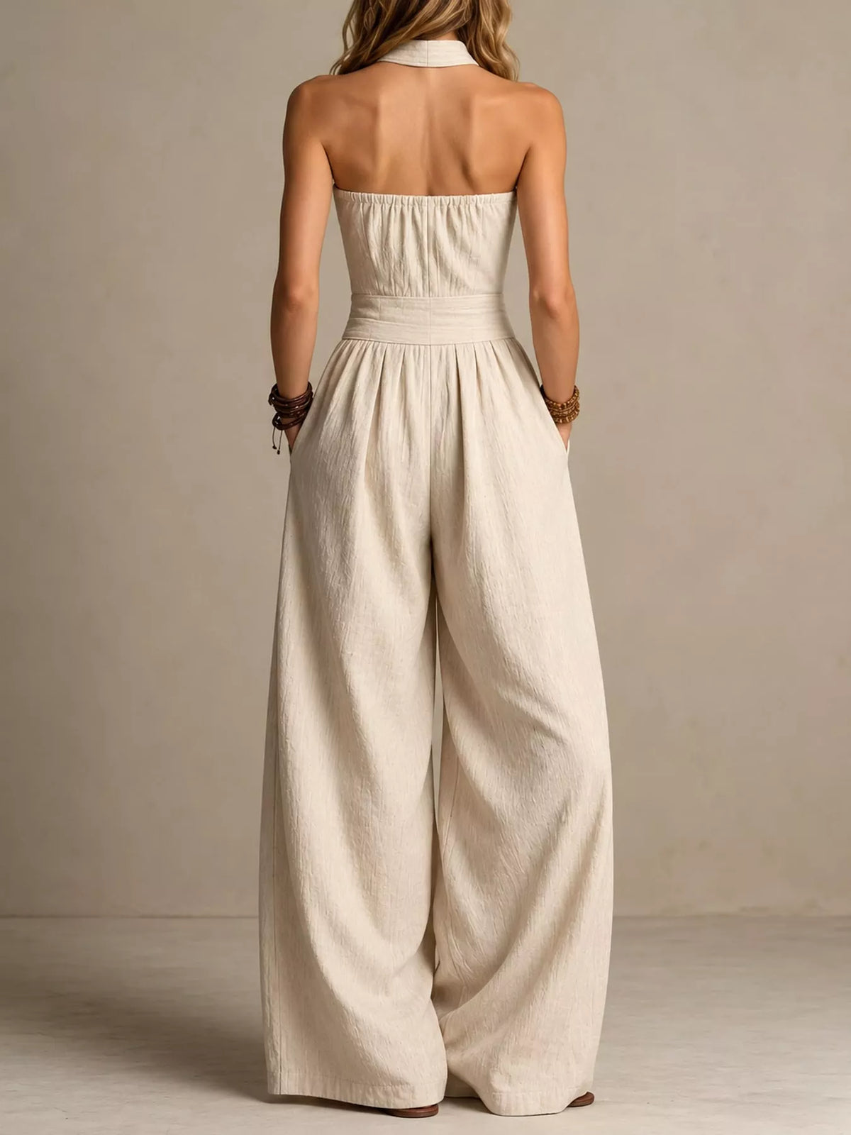 Off-white linen halter wide-leg jumpsuit, back view with open upper and wide pant legs