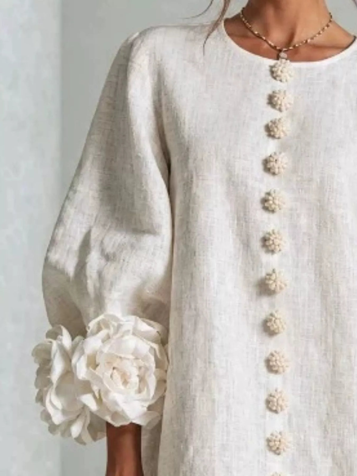 Off-white round-neck polyester dress with vertical button placket and 3D floral cuff applique
