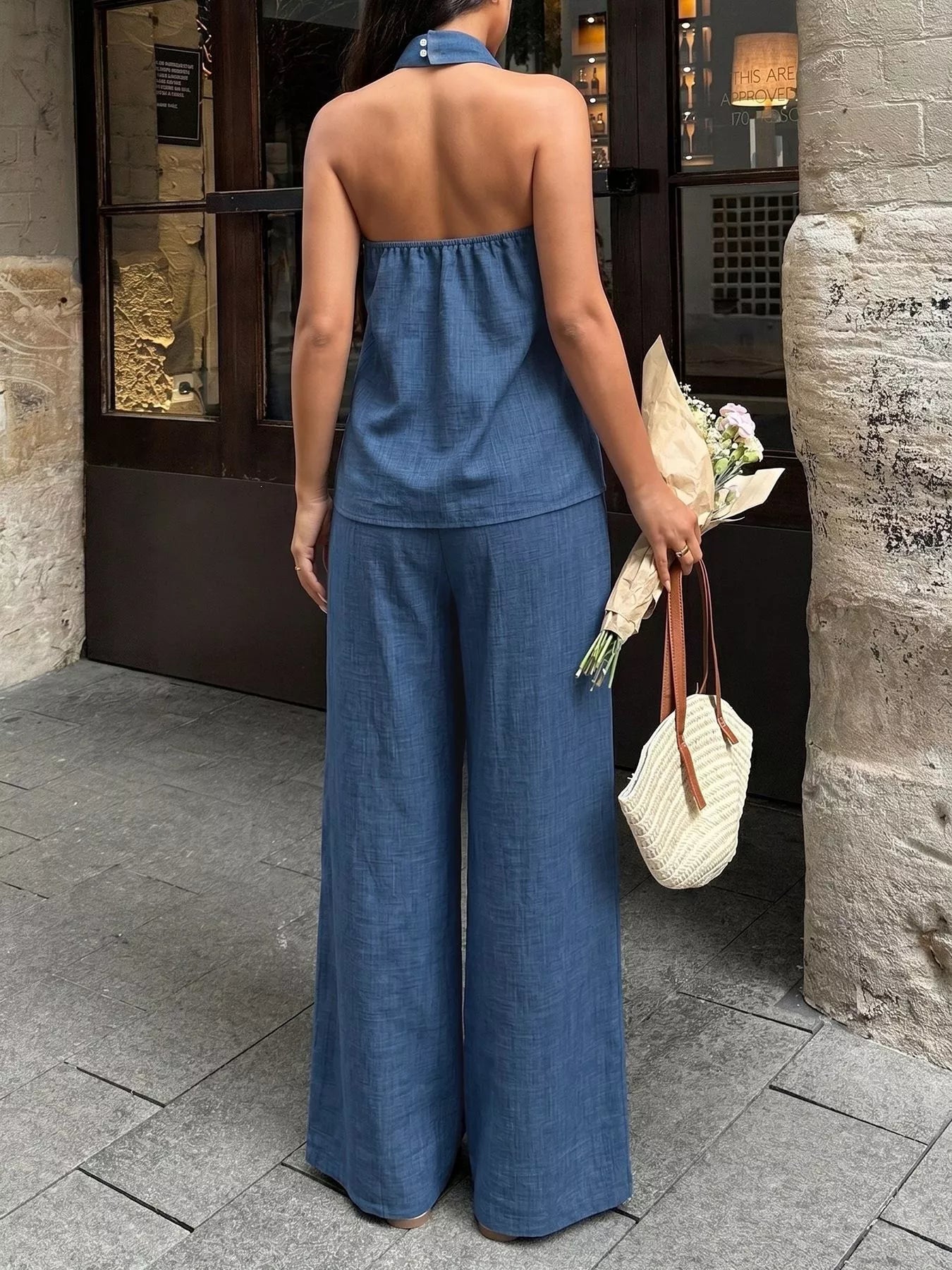 Navy blue halter neck top and wide-leg pants set shown from the back