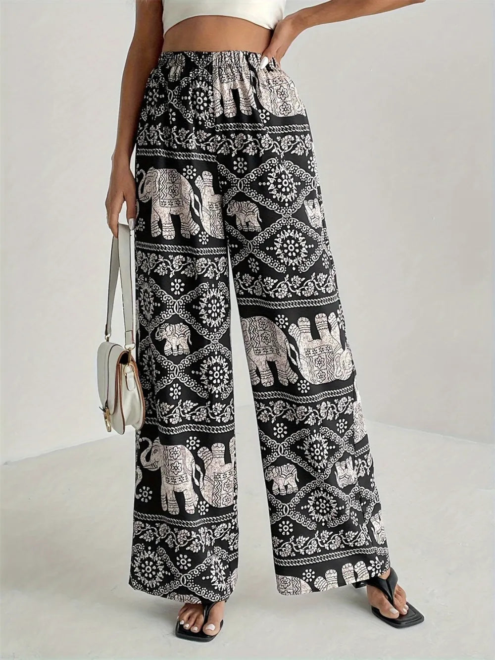 Black printed wide-leg pants with elephant pattern, elastic waist and drawstring
