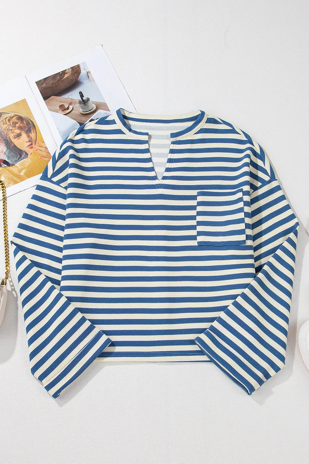 Blue and white striped long-sleeve top with V-neck and chest pocket