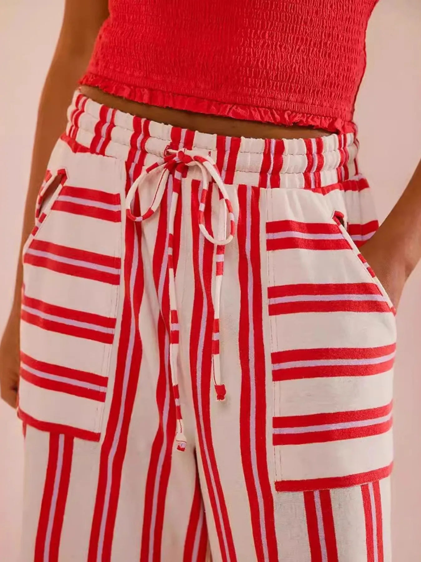Red-and-white striped wide-leg drawstring pants with elastic waistband and tie