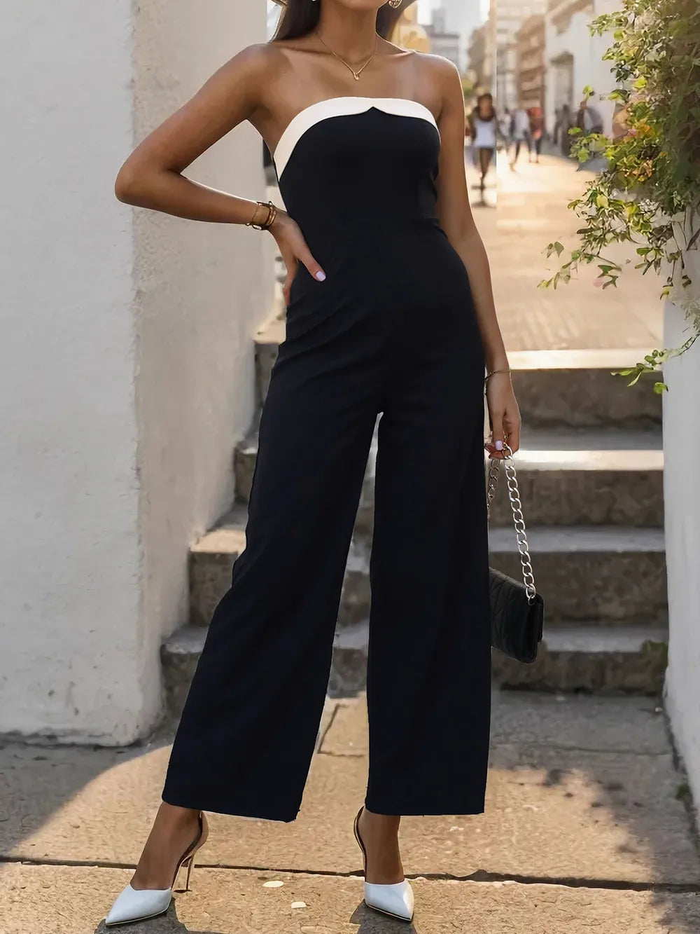 Black tube sleeveless wide-leg jumpsuit with white contrast neckline and wide legs
