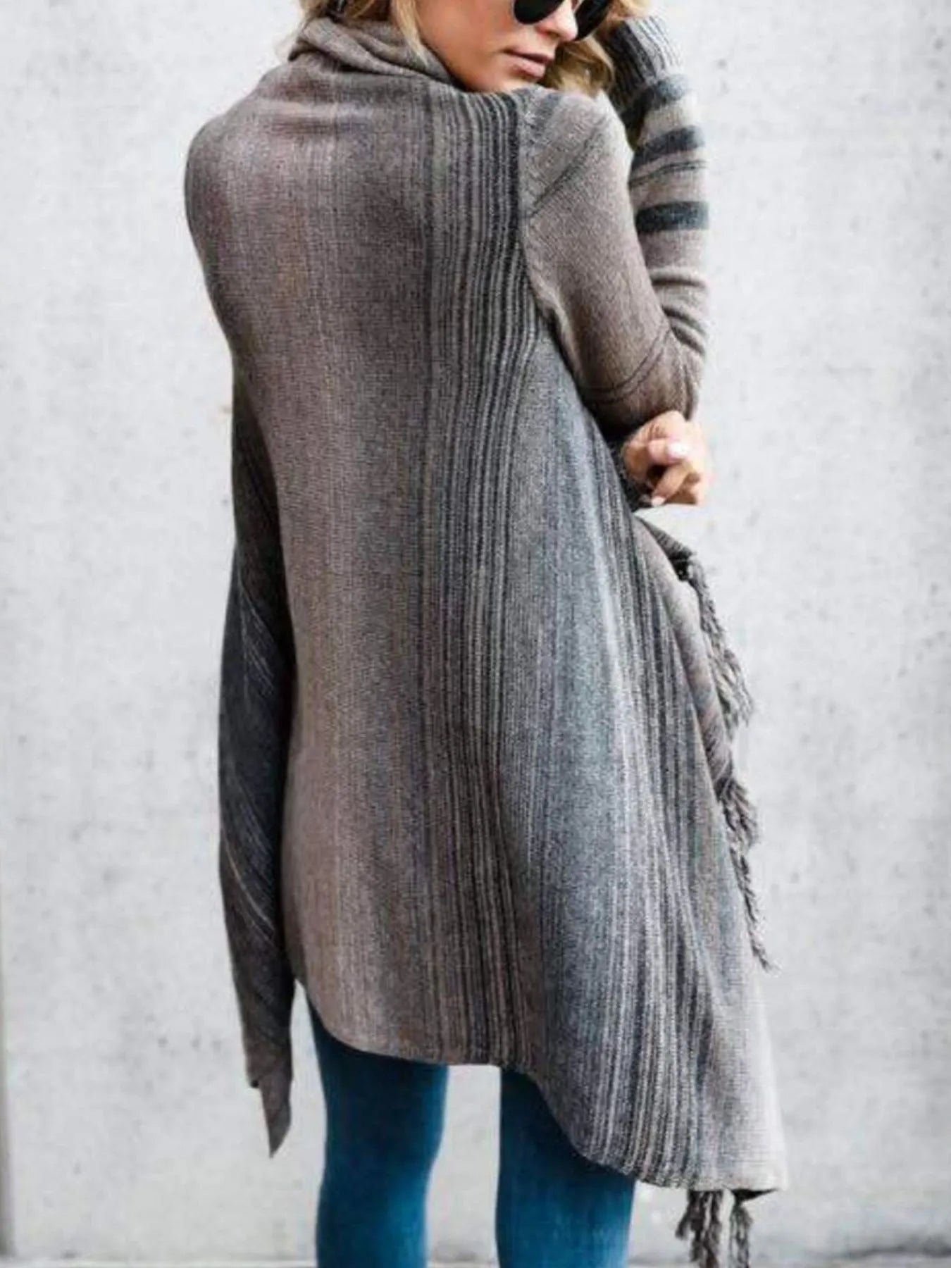 Gray striped long wrap cardigan with long sleeves and dangling fringe at hem