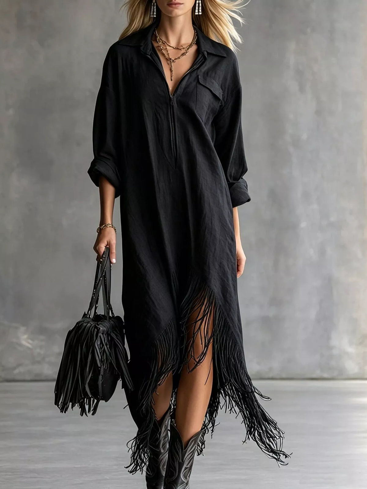 Black midi dress with front zipper, pockets, and fringe hem detail