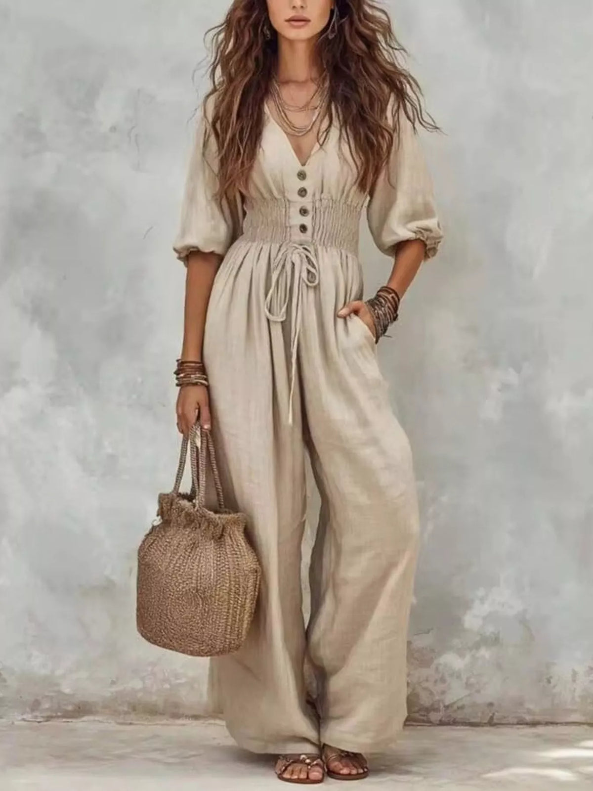 White v-neck smocked-waist wide-leg jumpsuit with button front and side pockets
