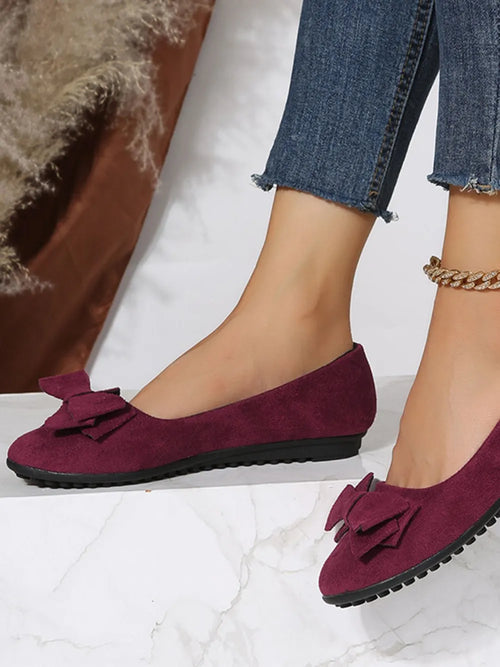 Burgundy suede round-toe flat slip-on shoes with bow detail and scalloped trim