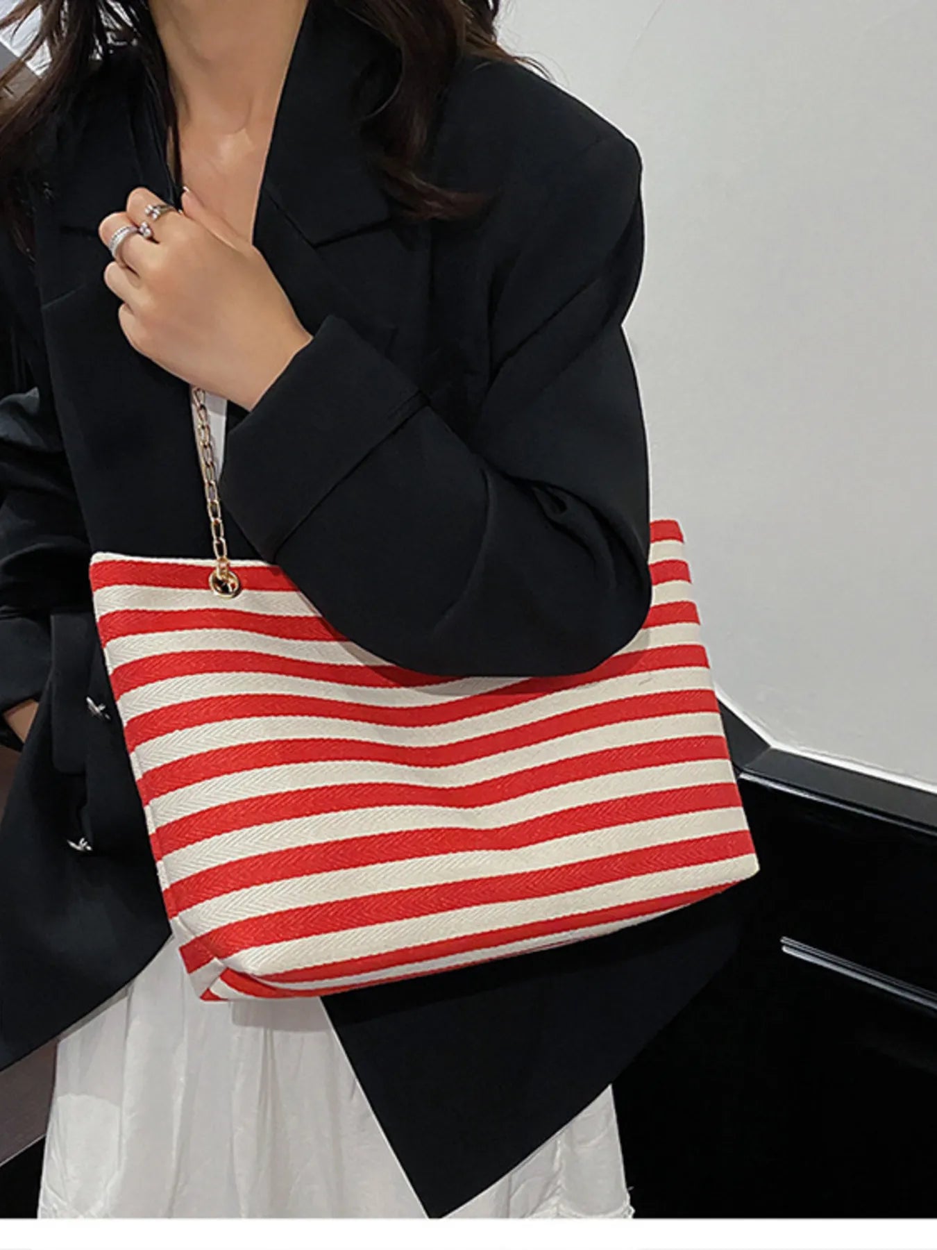 Striped shoulder bag with chain detail, red/white stripes, black chain strap on model