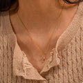 Gold-plated zircon cross necklace with small clear stones on a fine gold chain