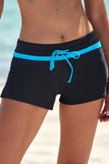 Black swim shorts with turquoise drawstring, elastic waistband, side pockets