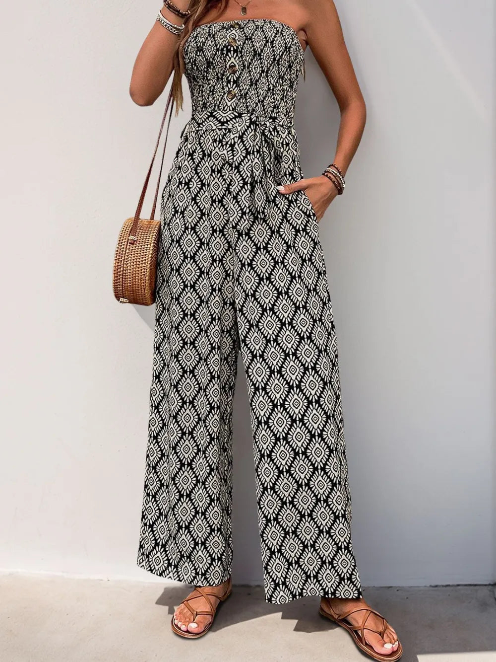 Black and white printed smocked sleeveless jumpsuit with draped smocked bodice, wide-leg