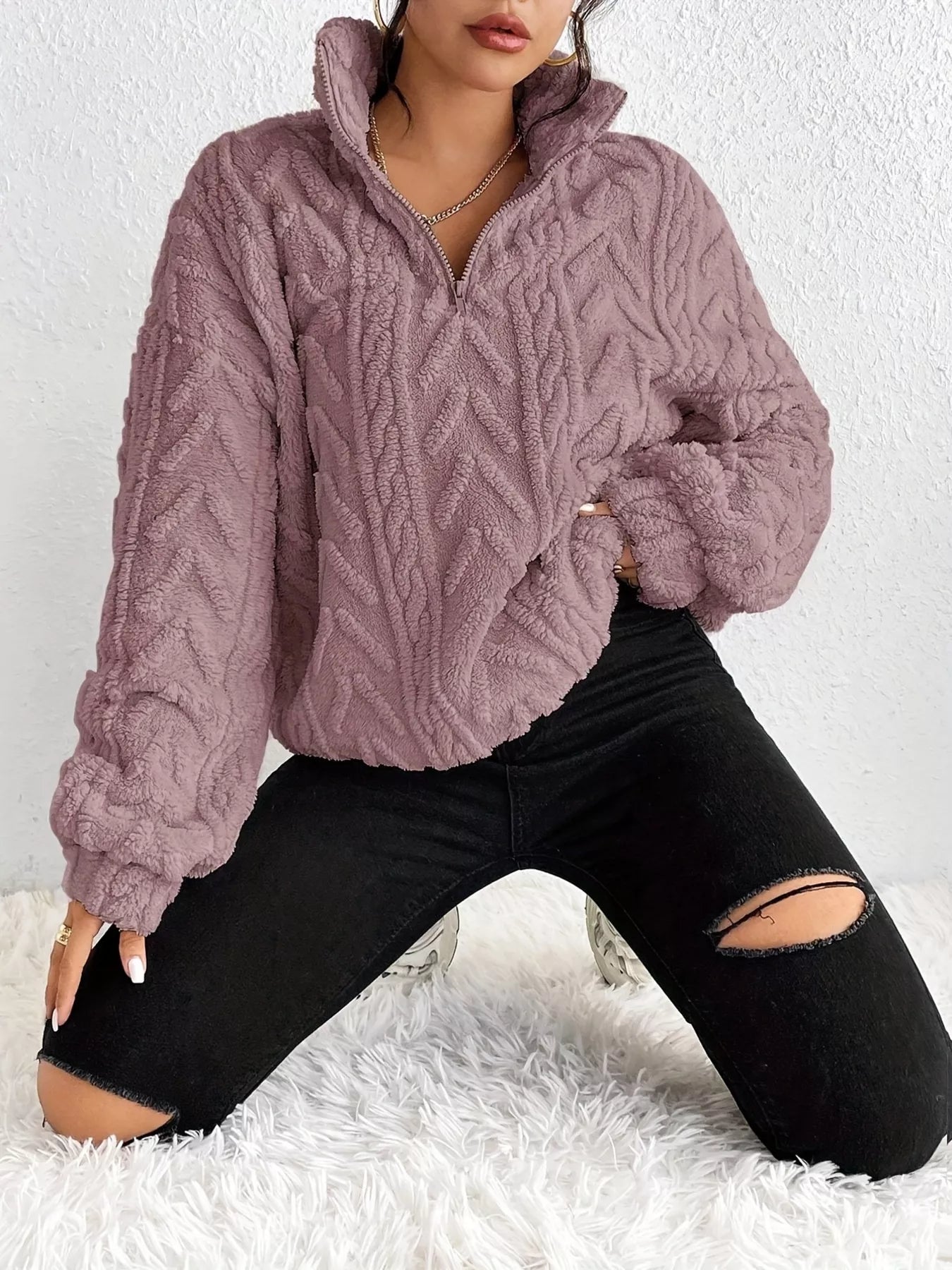 Light purple sherpa quarter-zip sweatshirt with cable knit texture and ribbed hem
