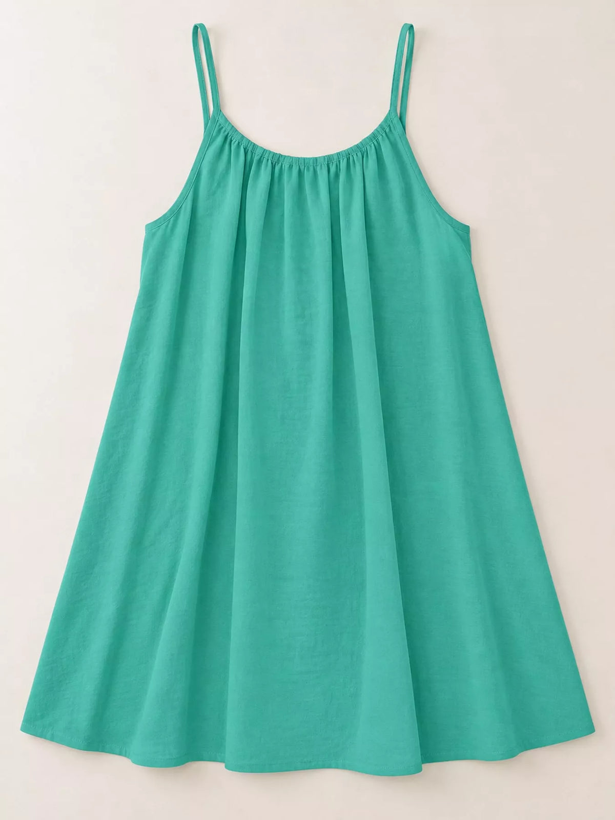 Emerald green spaghetti strap ruched mini dress with flared skirt