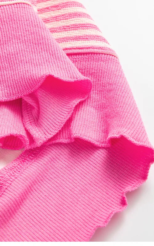 Close-up of pink ribbed sweatshirt cuff and hem with striped knit
