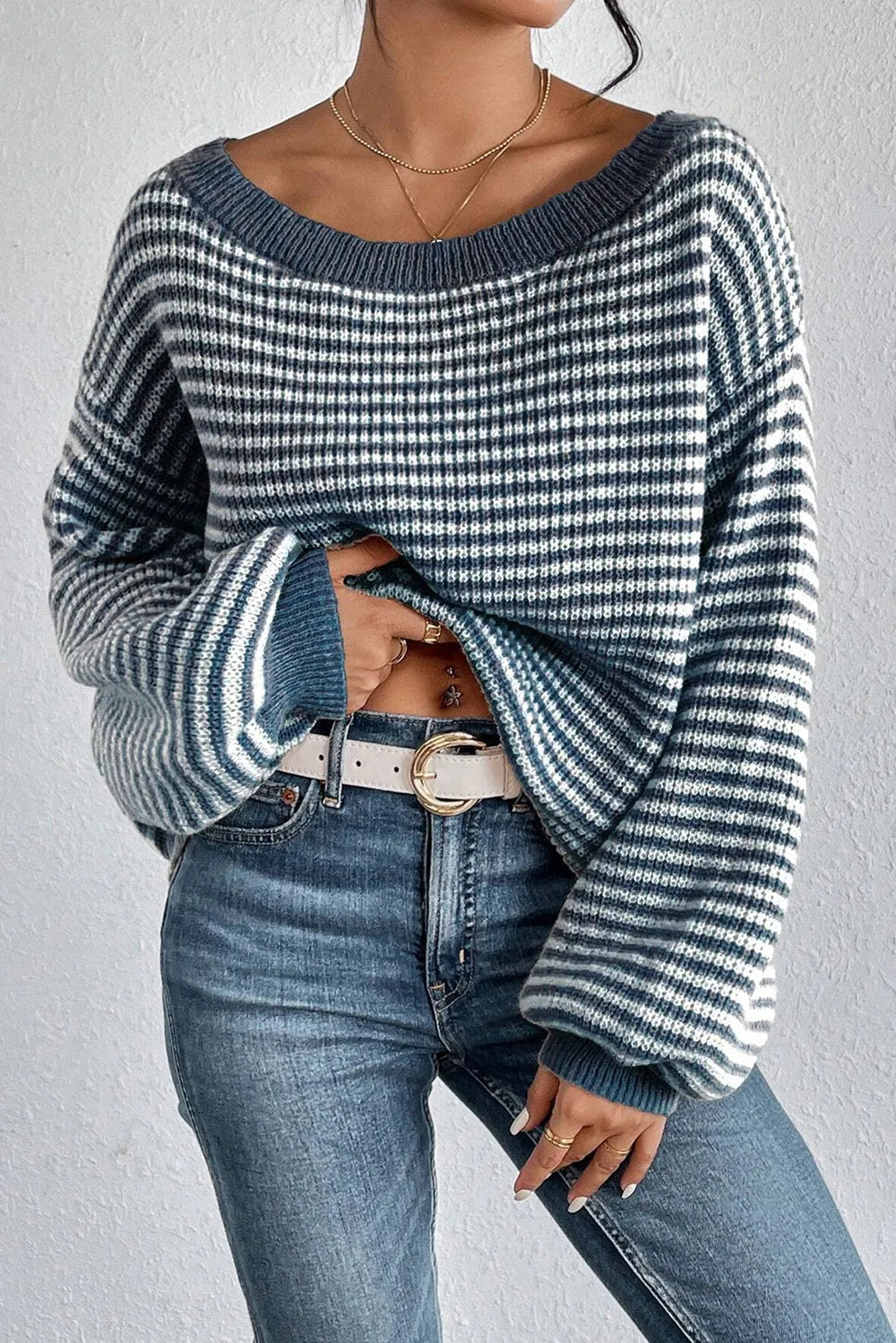 Blue and white striped boat-neck sweater with dropped shoulders and ribbed trim