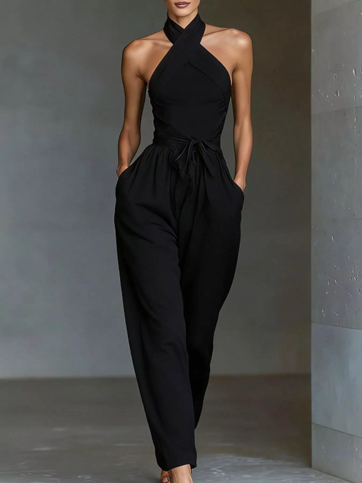 Black halter neck wide-leg jumpsuit with waist tie and draped front