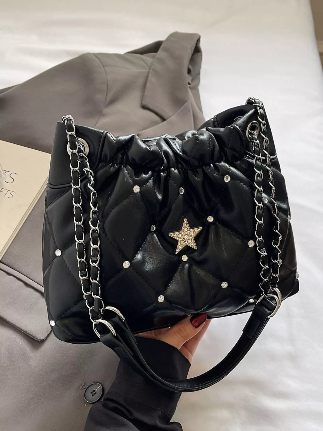 Quilted black PU shoulder bag with rhinestone-studded star decor and silver chain strap, small size.