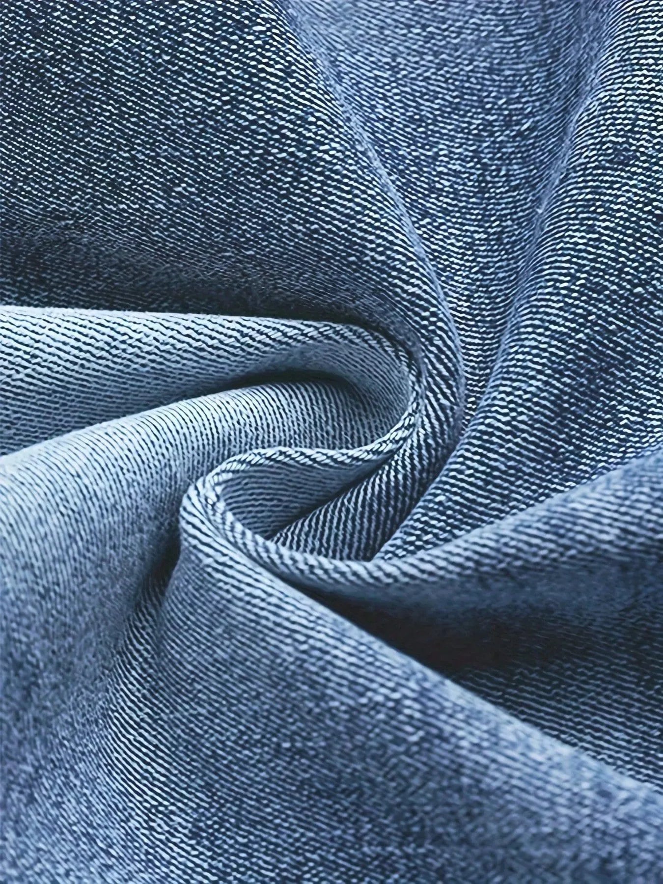 Light blue denim fabric close-up with textured twill weave