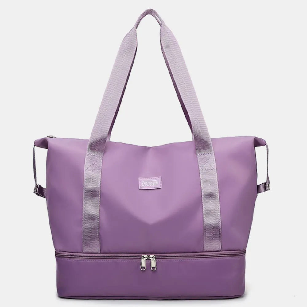 Lavender purple nylon travel duffel bag with wide straps and front zip pocket.