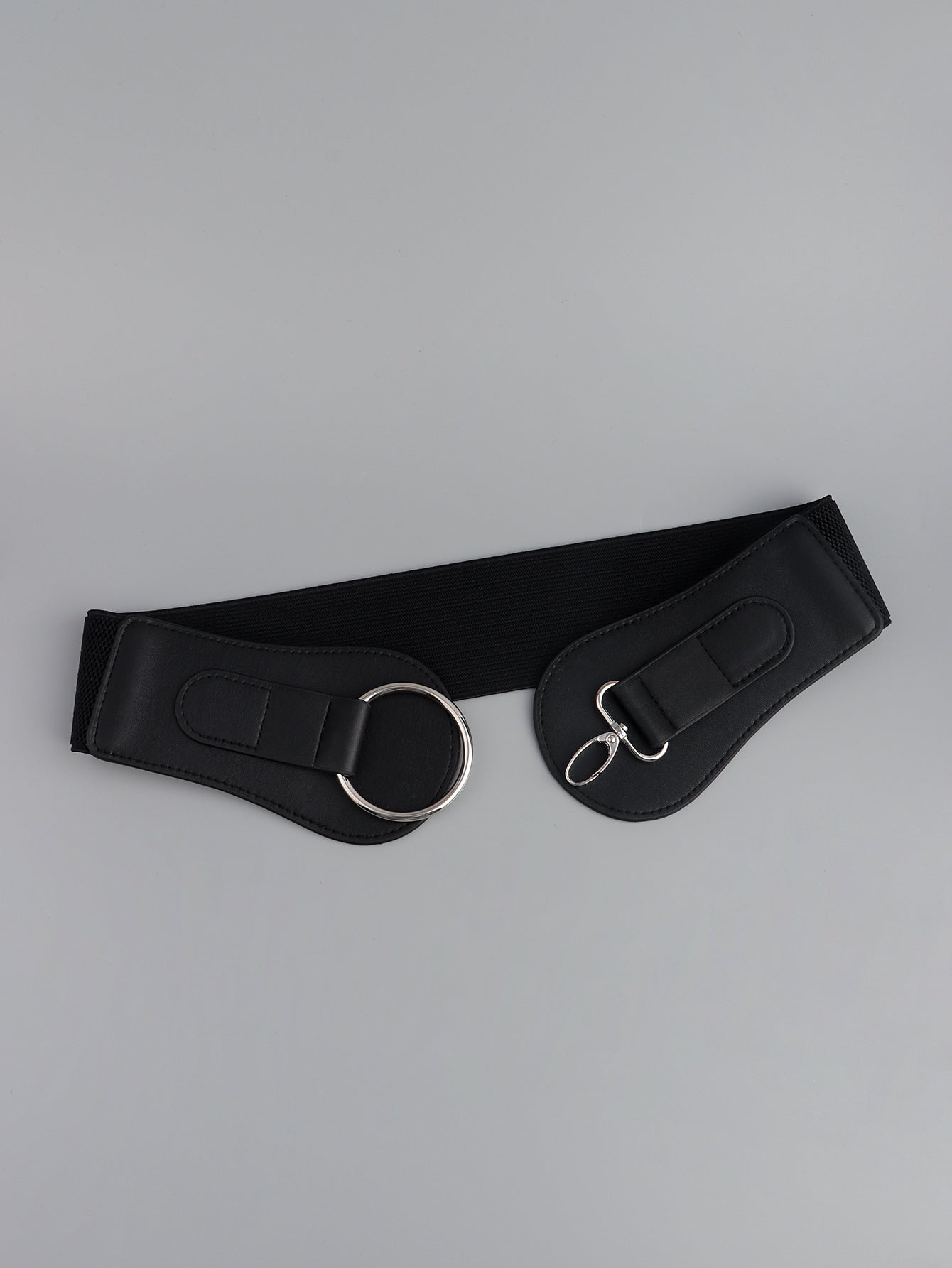 Black wide elastic belt laid flat with silver O-ring and D-ring buckle ends