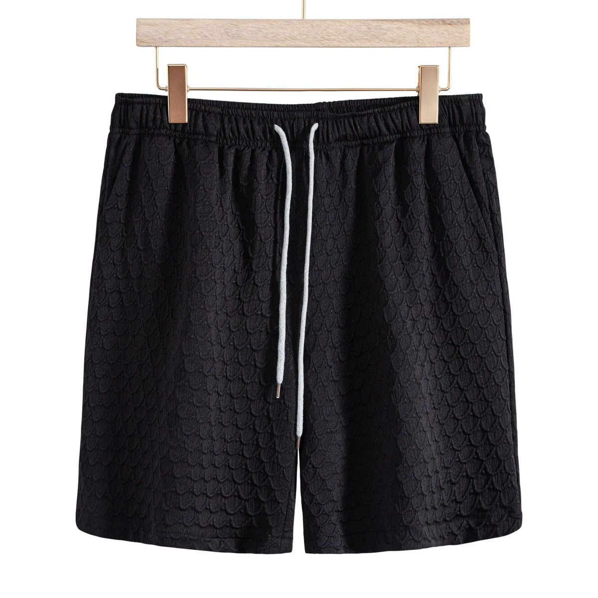 Men's black lightweight drawstring shorts with elastic waistband and textured scale pattern