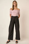 Black high-waisted wide-leg pants with deep front pleats and side pockets