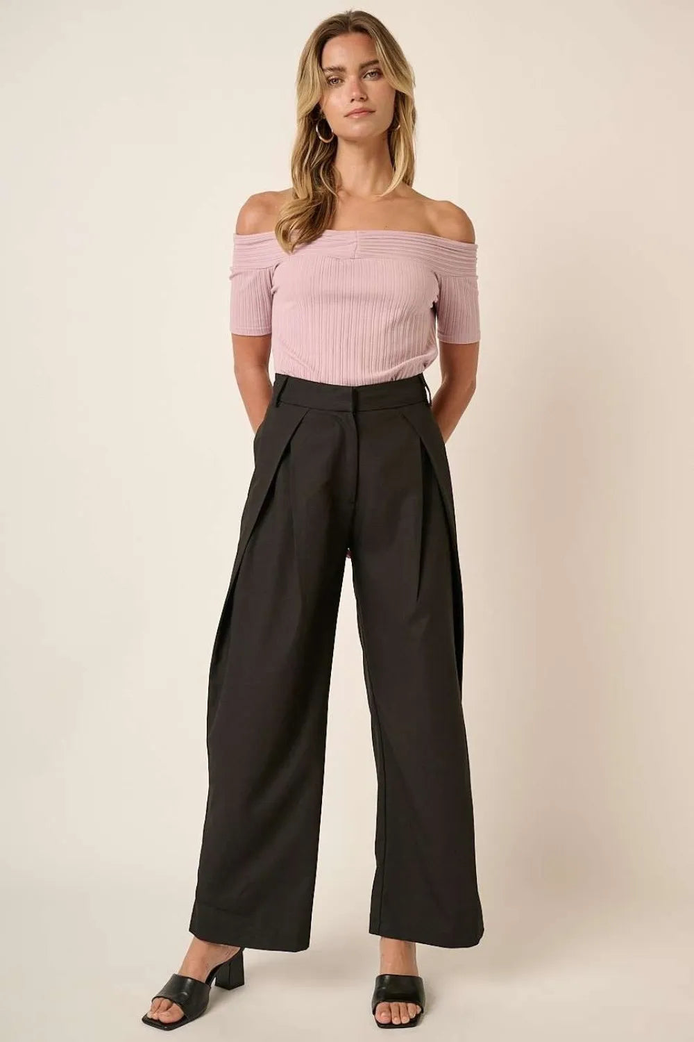 Black high-waisted wide-leg pants with deep front pleats and side pockets