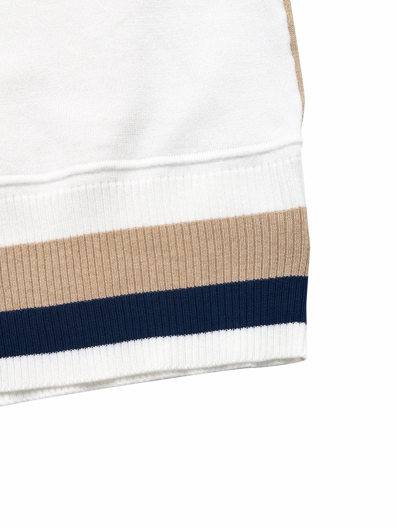 Ribbed hem detail on a color block sweater in navy and beige with white paneling