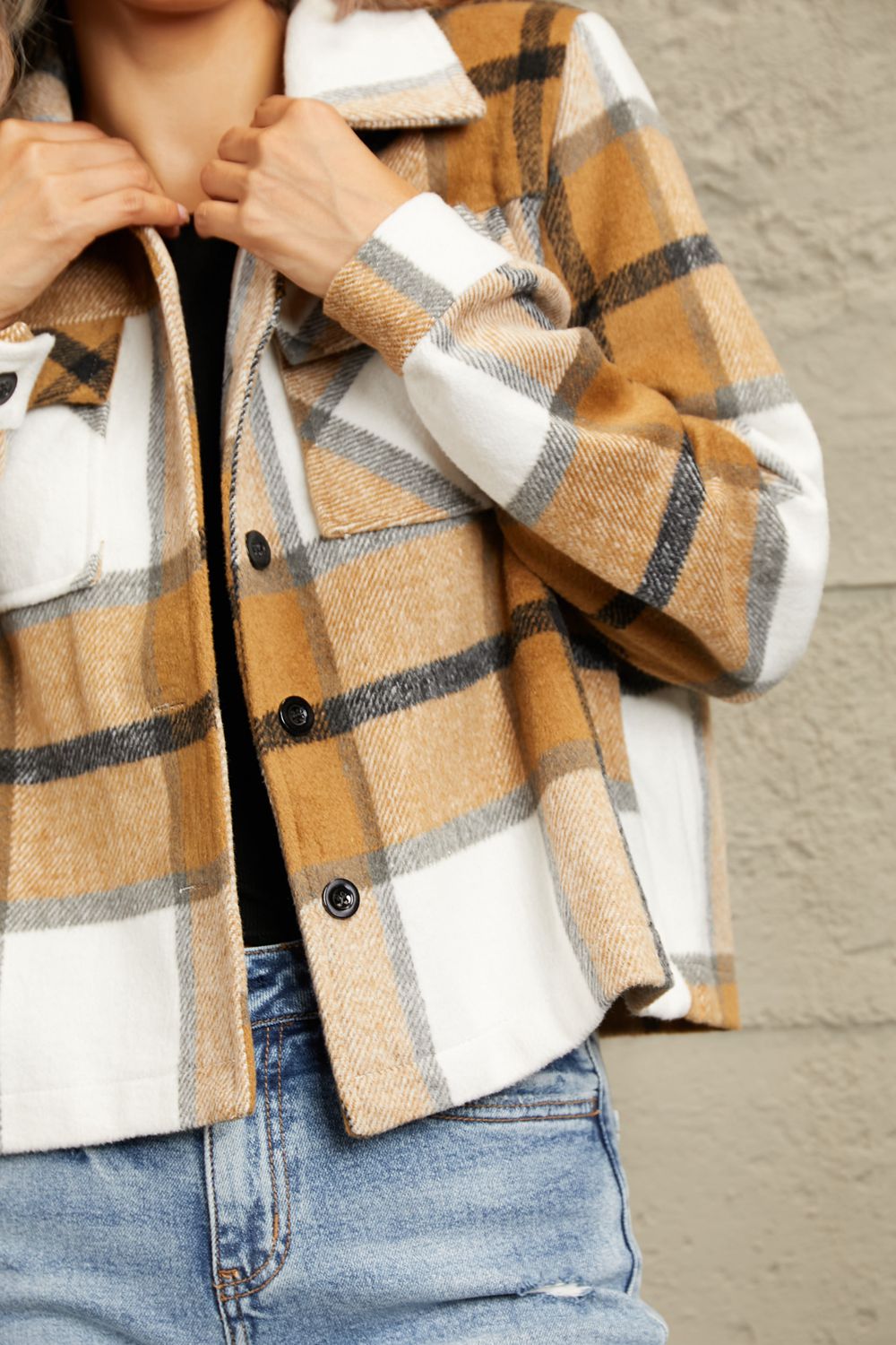 Camel plaid jacket detail with button placket and fleece-trim cuff, chest pocket