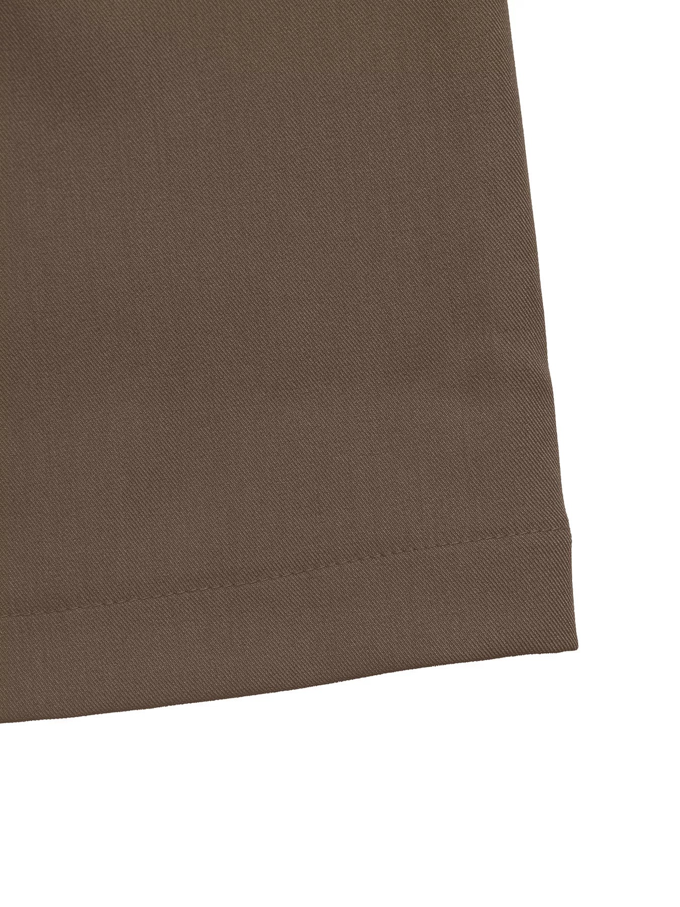 Brown wide-leg pants hem with clean stitched edge, close-up.