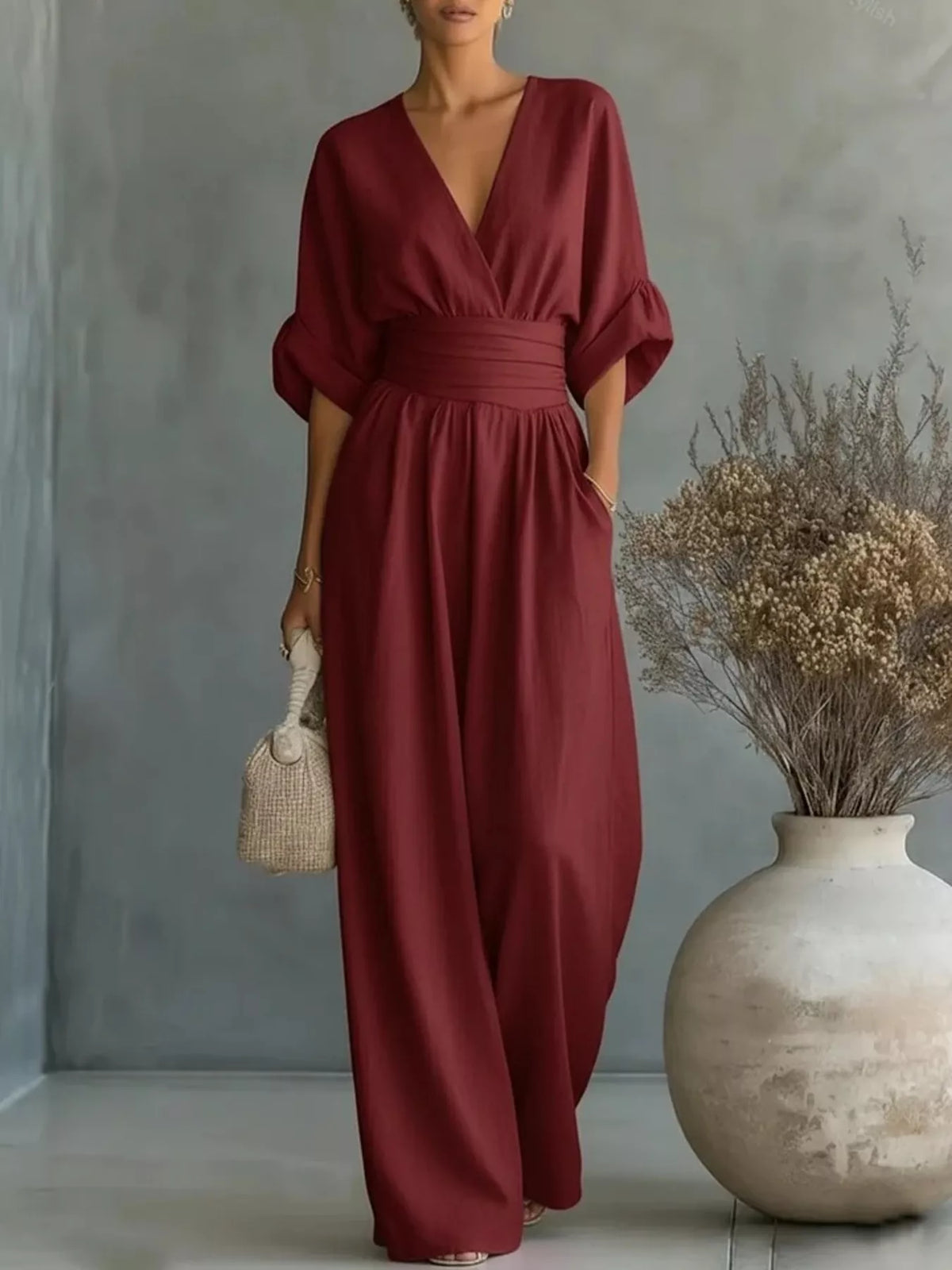 Wine red wide-leg jumpsuit with V-neck, half sleeves, and gathered waist
