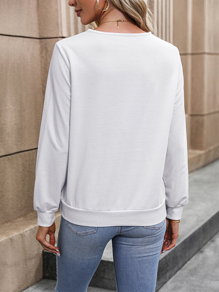 White long-sleeve blouse with rounded neckline and relaxed fit, back view